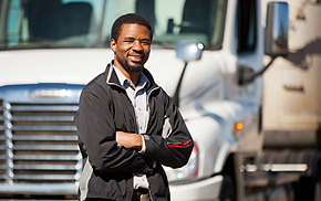 man standing in front of a white commercial motor vehicle