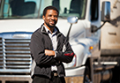 man standing in front of white commercial motor vehicle